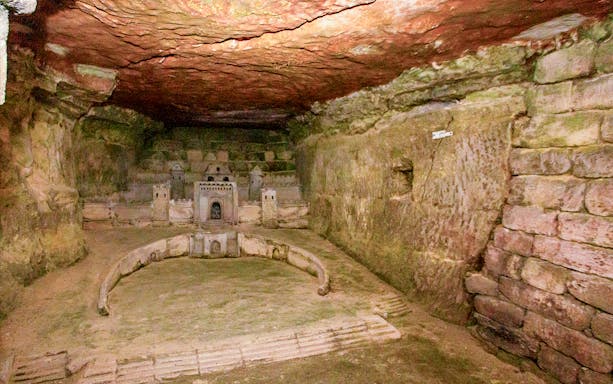 Paris Catacombs model of Port-Mahon carved into limestone wall.