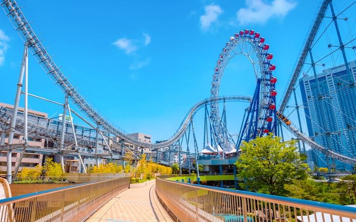 Roller coaster and Big O Ferris Wheel at Dome City amusement park, Tokyo.