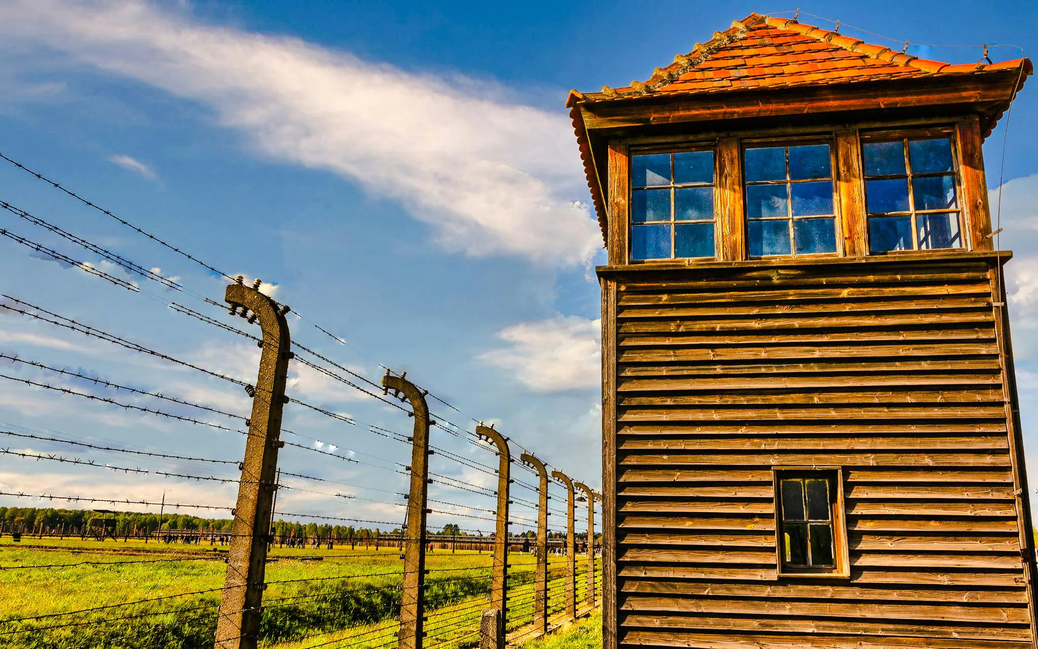 Watchtower and barbed wire fence at Auschwitz-Birkenau concentration camp.