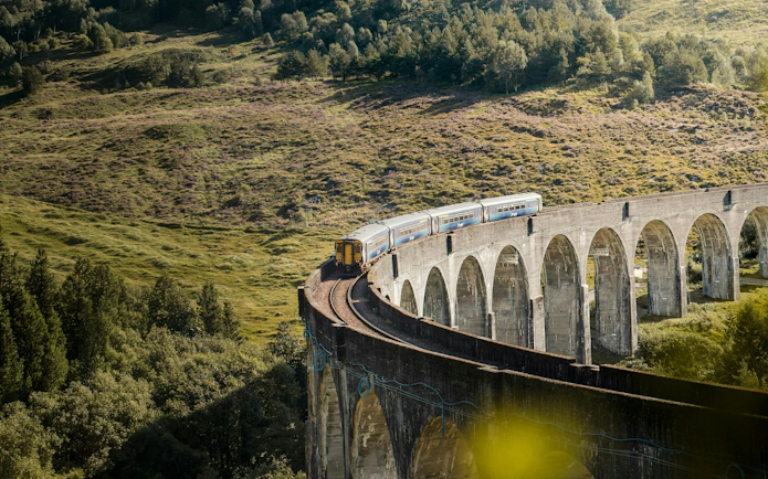 Train crossing the Glenfinnan Viaduct on the National Rail network in Scotland.