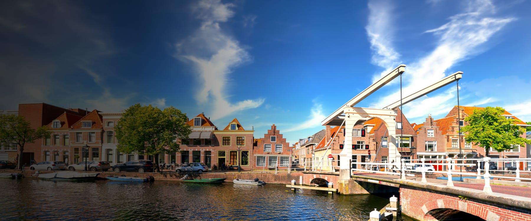 Historic drawbridge and canal in Alkmaar, Netherlands, with traditional Dutch houses.