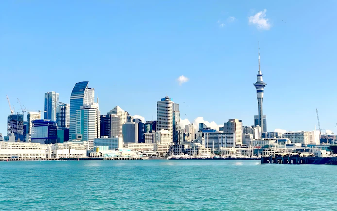 Auckland skyline with Sky Tower viewed from the harbor during a wine and cheese cruise.