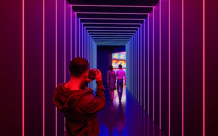 Visitors photographing the illuminated tunnel at Camp Nou Barca Museum.