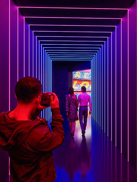 Visitors photographing the illuminated tunnel at Camp Nou Barca Museum.