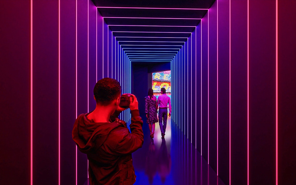 Visitors photographing the illuminated tunnel at Camp Nou Barca Museum.