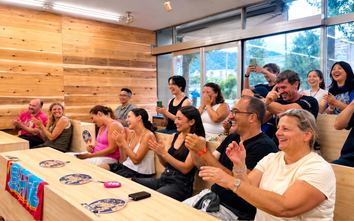 Audience cheering during a live sumo show in Kyoto.