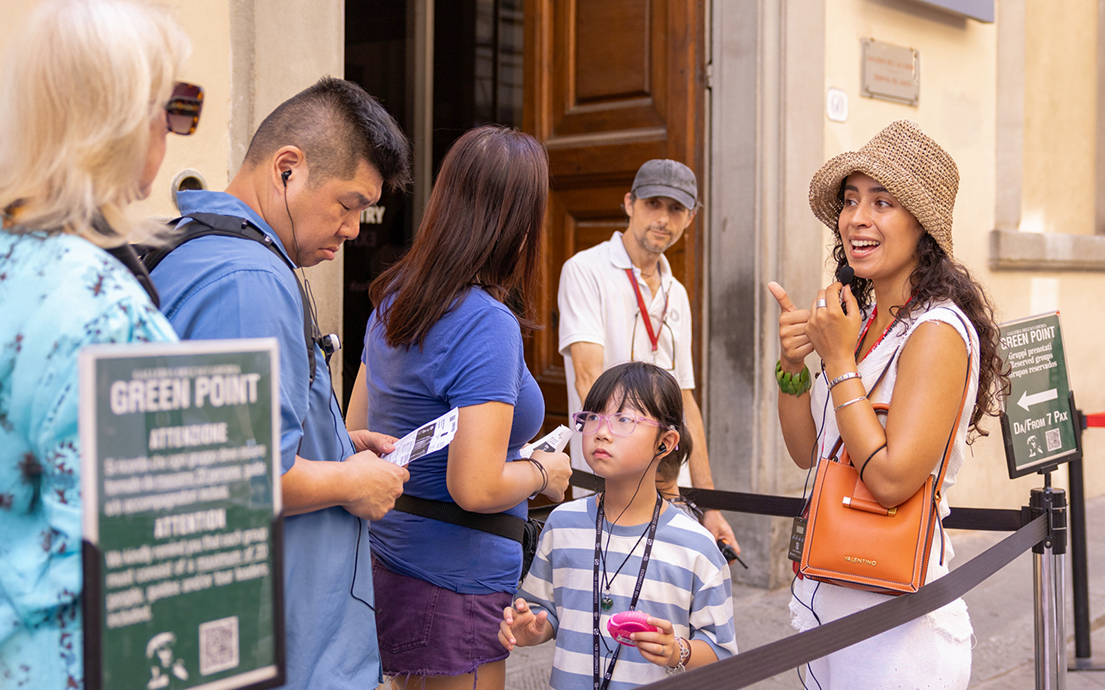 Tour group with guide at Accademia Gallery, Florence, viewing Michelangelo's David statue.