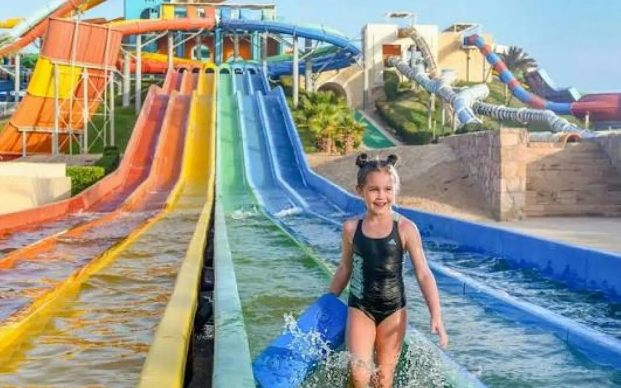 Child enjoying colorful water slides at Makadi Water World Aqua Park, Hurghada.