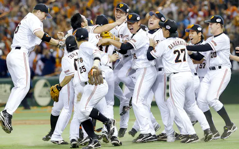 Baseball team celebrating victory on the field.
