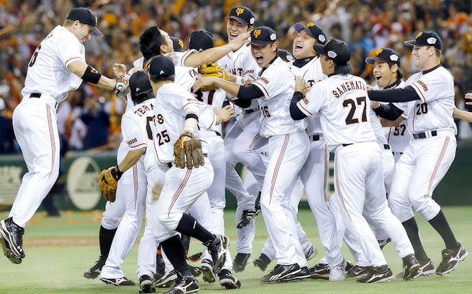 Baseball team celebrating victory on the field.