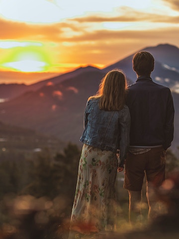 Couple watching sunrise over Mount Batur, Bali.