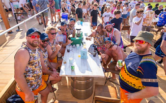 Group enjoying drinks at Emirates Dubai 7s Sunroom Hospitality area.