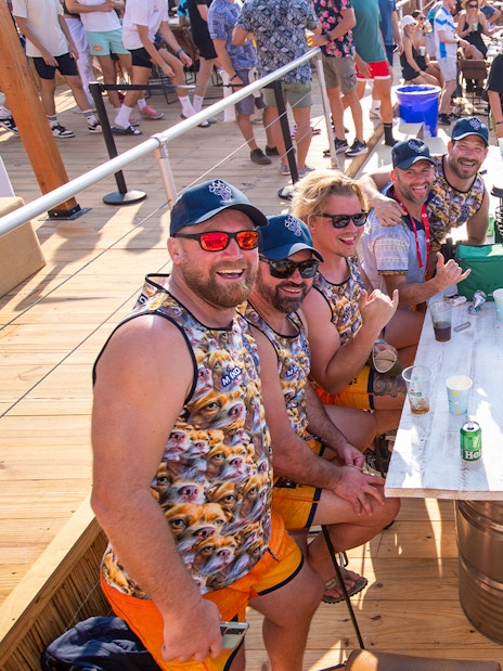 Group enjoying drinks at Emirates Dubai 7s Sunroom Hospitality area.