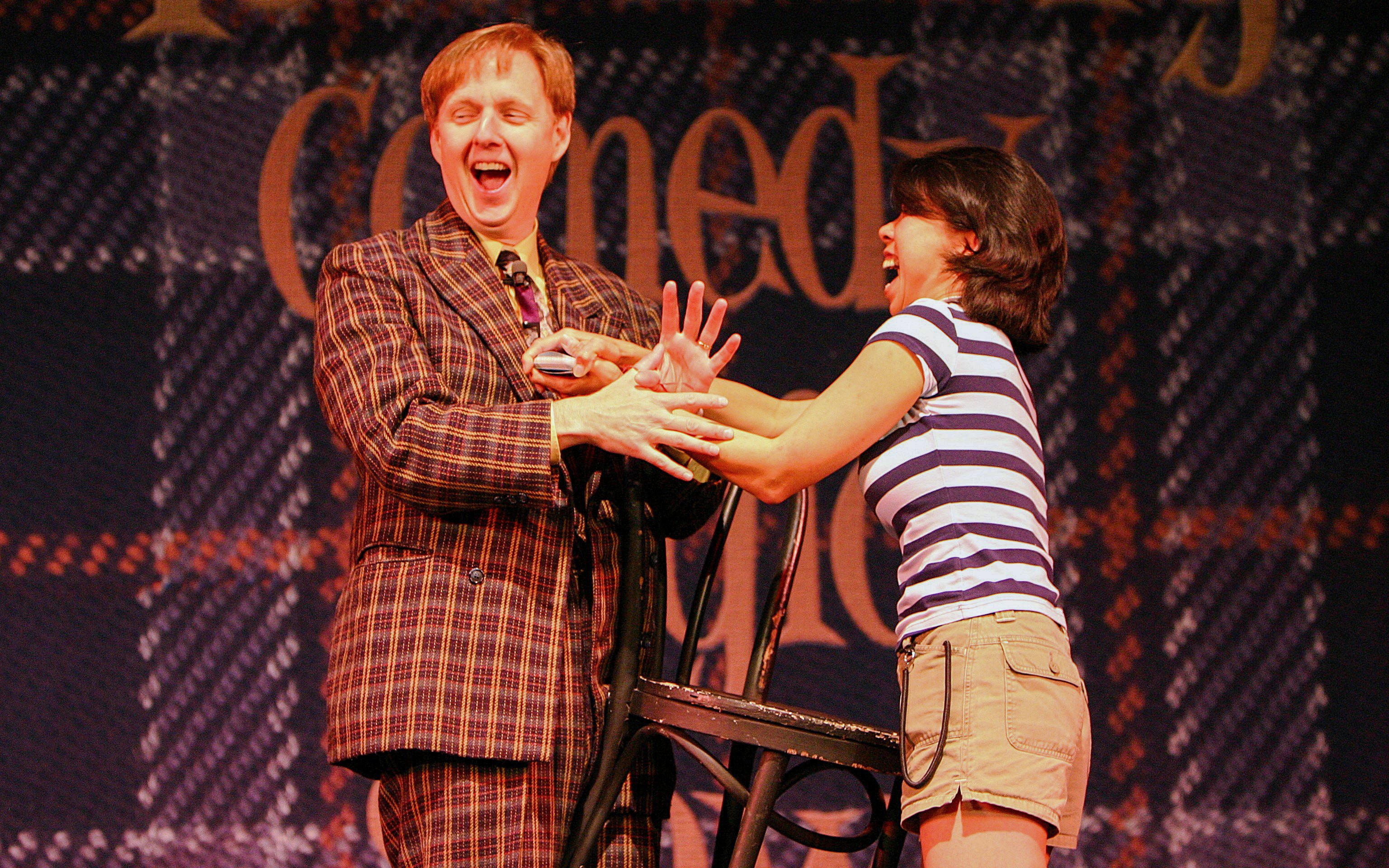 Magician performing with audience member at The Mac King Comedy Magic Show, Vegas.