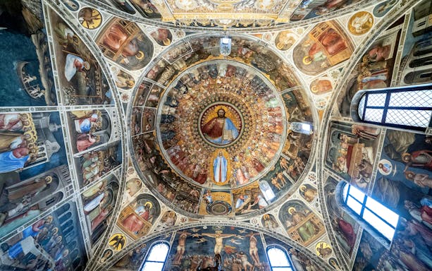 Dome frescoes in Padua's UNESCO Urbs Picta, featuring religious scenes and figures.
