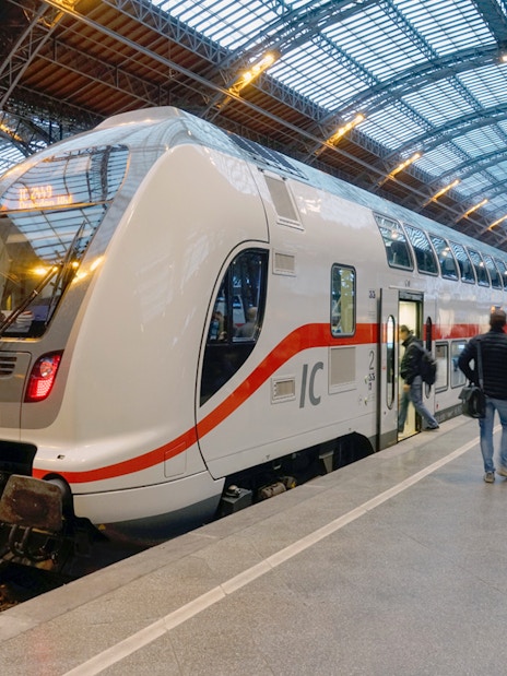 Euro Rail train at a German station platform with passengers boarding.