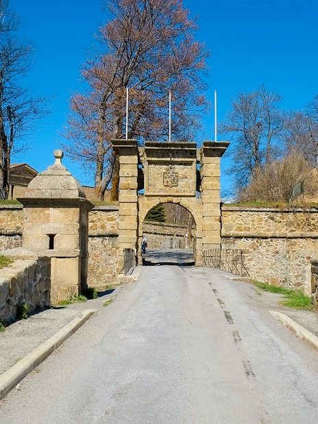 Gates to medieval fortress at Mont Louis, France, with stone walls and archway.