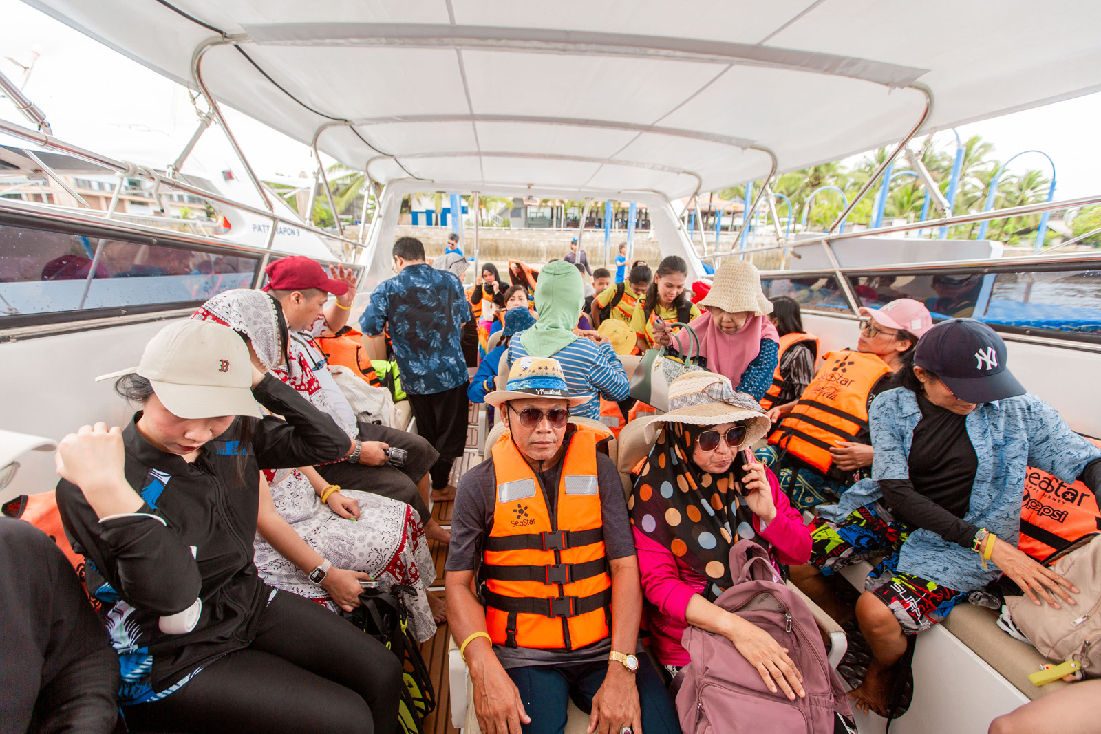 Tourists on a speedboat wearing life jackets during Surin Islands tour, Thailand.