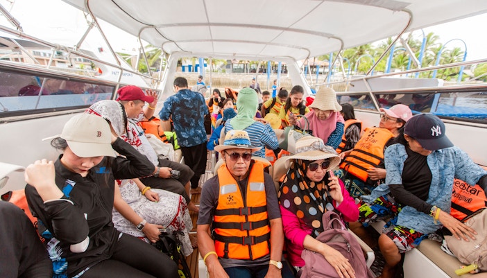 Tourists on a speedboat wearing life jackets during Surin Islands tour, Thailand.