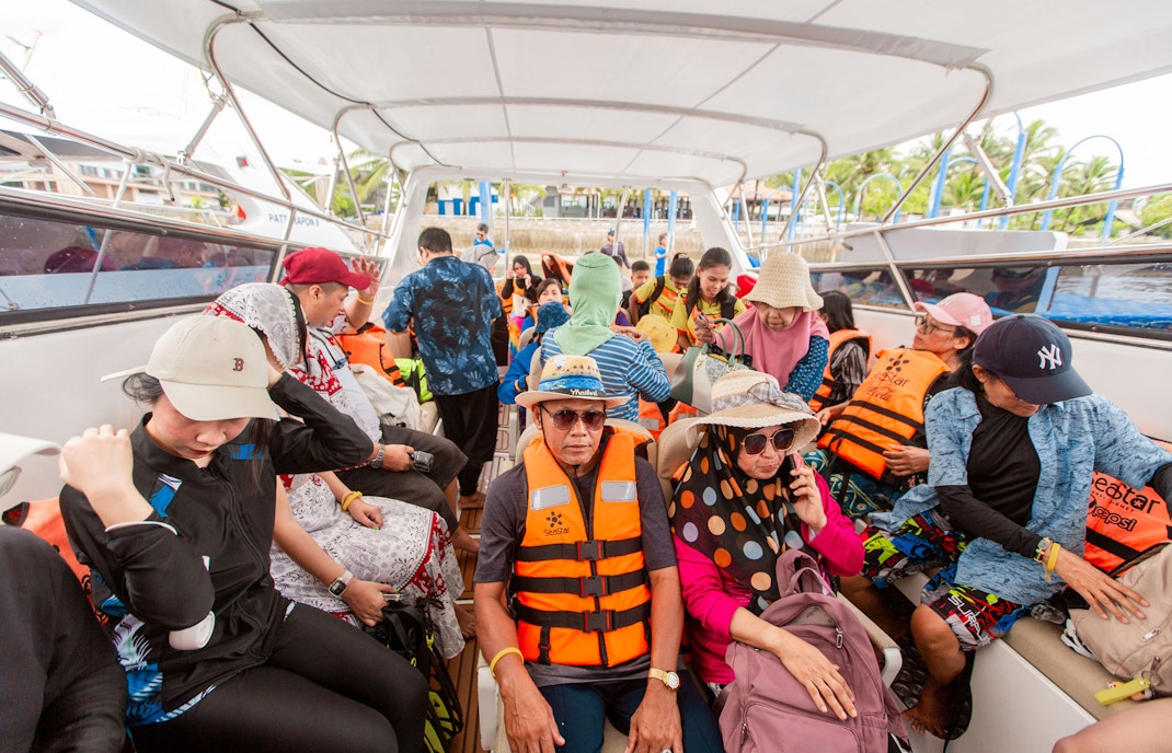 Tourists on a speedboat wearing life jackets during Surin Islands tour, Thailand.