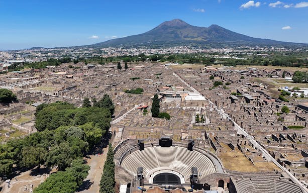 Aerial view of Pompeii Ruins with Mount Vesuvius in the background, Naples.