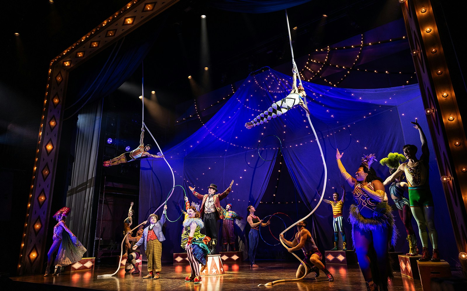 Acrobats performing on stage with ropes in a circus-themed show, "Water for Elephants.