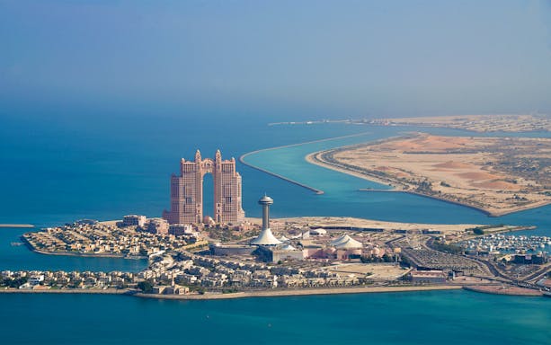 Aerial view of Abu Dhabi's skyline and coastline during a helicopter tour.