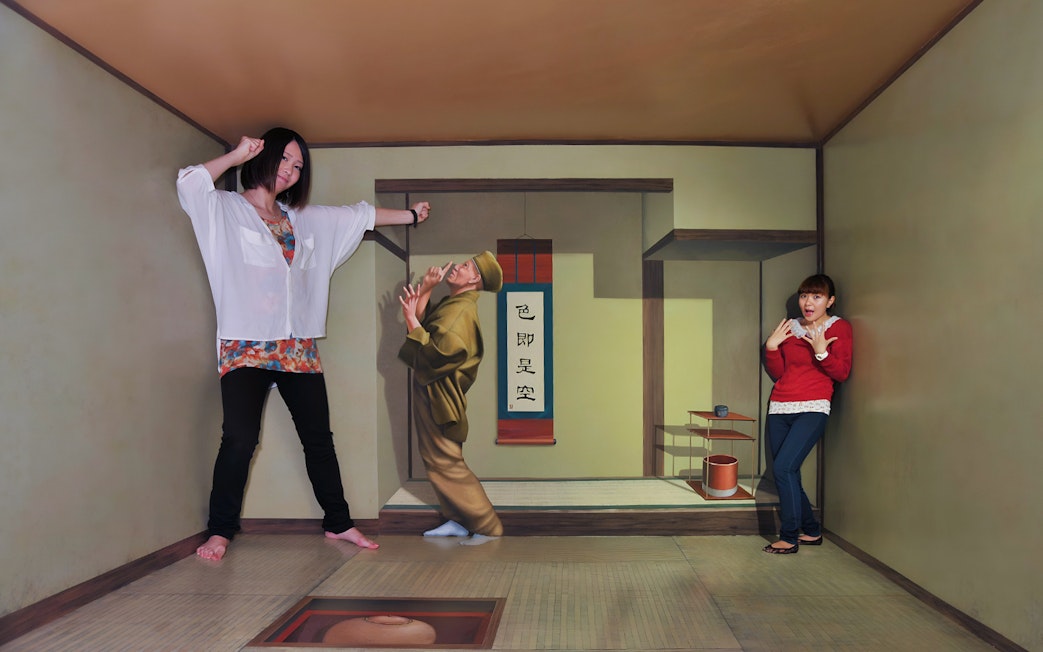 Visitors in an optical illusion room at TOEI Kyoto Studio Park.