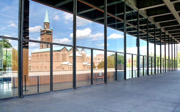 Reflection of church in glass facade of Neue Nationalgalerie, Berlin.