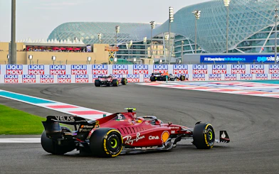 Formula 1 cars racing at Yas Marina Circuit, Abu Dhabi Grand Prix.