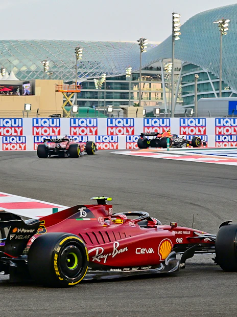 Formula 1 cars racing at Yas Marina Circuit, Abu Dhabi Grand Prix.