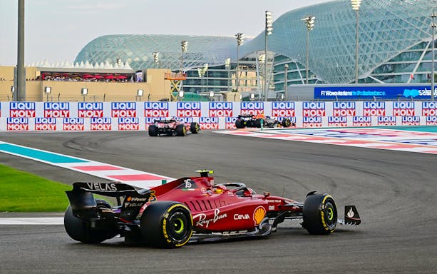 Formula 1 cars racing at Yas Marina Circuit, Abu Dhabi Grand Prix.