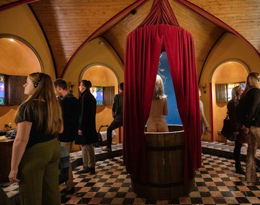 A woman inside a bathouse of medivial times