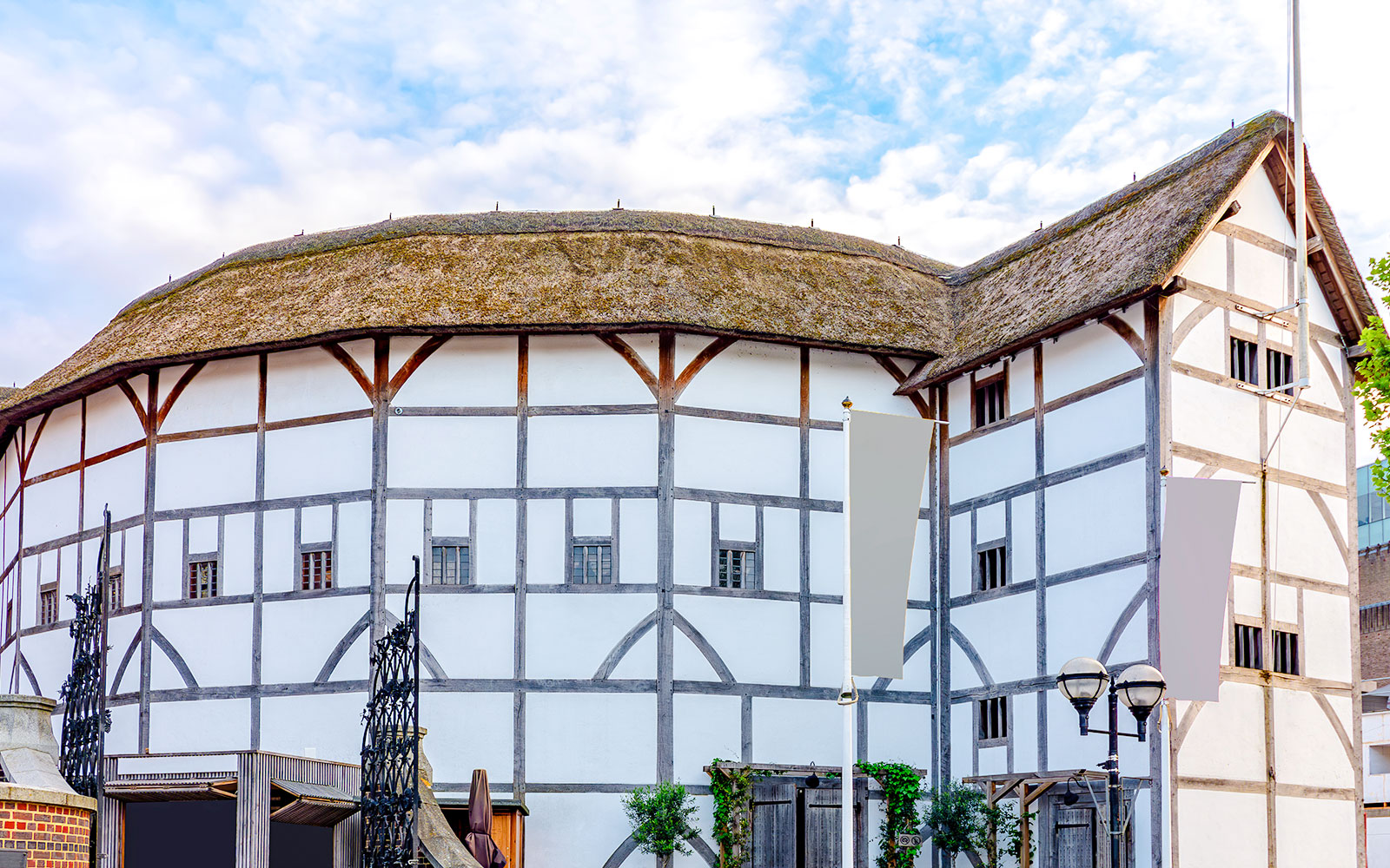 Shakespeare's Globe Theatre exterior with thatched roof and timber framing in London.