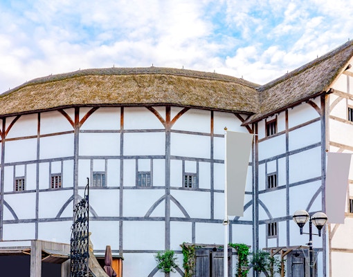 Shakespeare's Globe Theatre exterior with thatched roof and timber framing in London.