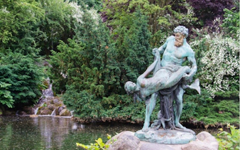 Statue of Neptune holding a mermaid in Viktoriapark, Berlin Kreuzberg.