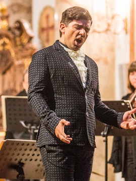 Opera singer performing at St. Charles Church concert in Vienna.