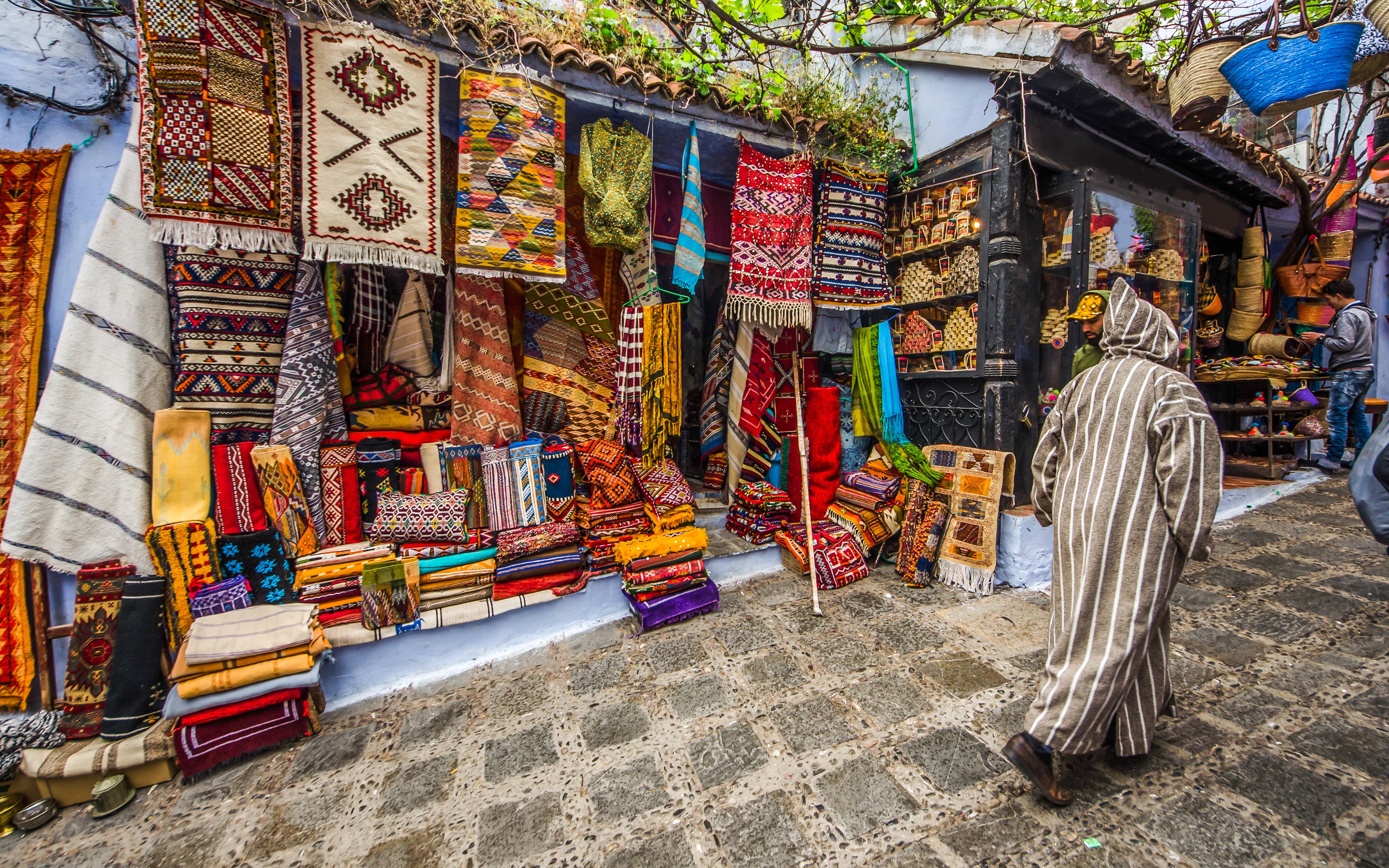 Colorful textiles displayed in a market in Chefchaouen, Morocco.