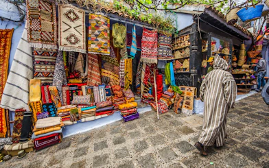 Colorful textiles displayed in a market in Chefchaouen, Morocco.