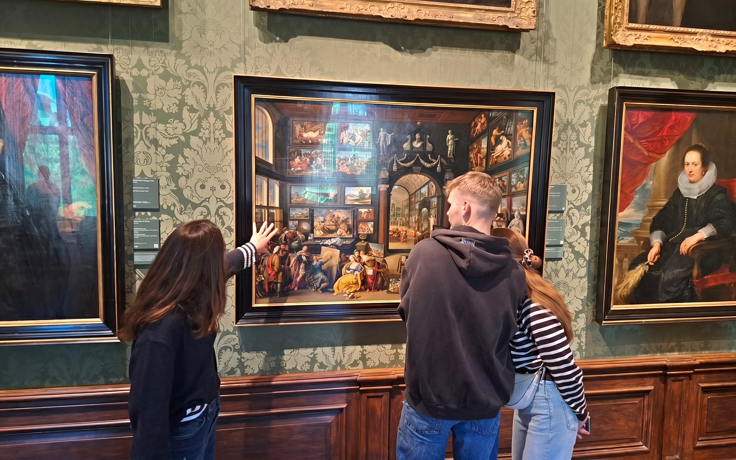 Visitors admiring artwork at Mauritshuis museum in The Hague.
