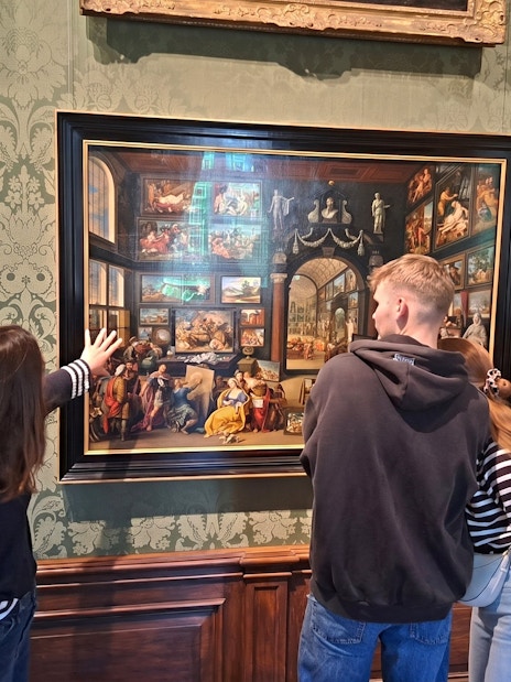 Visitors admiring artwork at Mauritshuis museum in The Hague.