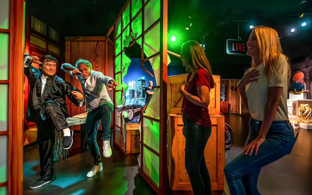 Visitors interacting with wax figures at Madame Tussauds Dubai.