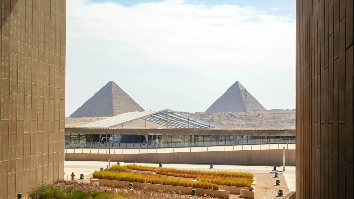 Great Pyramid of Giza viewed from Grand Egyptian Museum terrace with landscaped foreground.