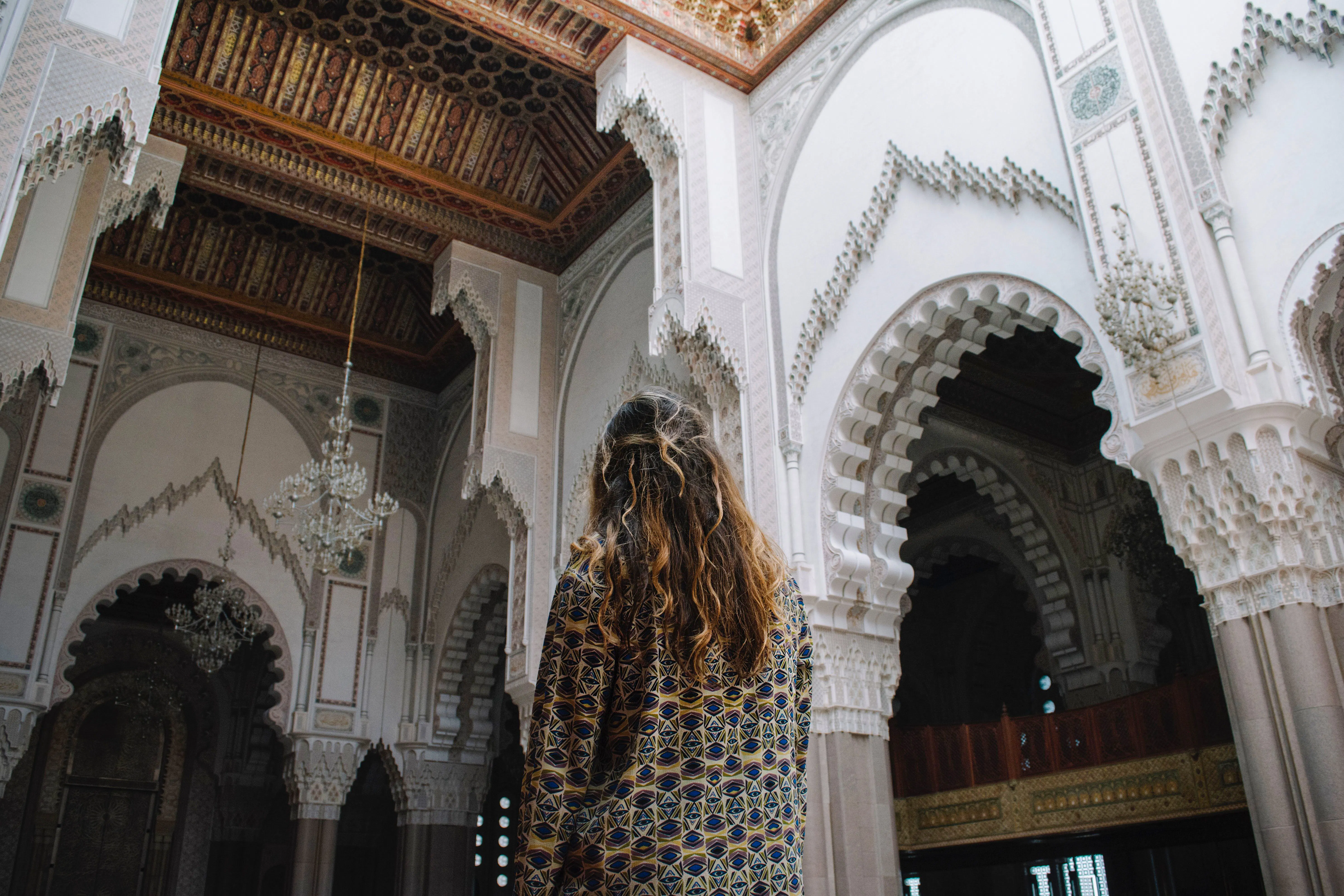 Interior of Moroccan architecture with intricate arches and chandeliers, Fez.