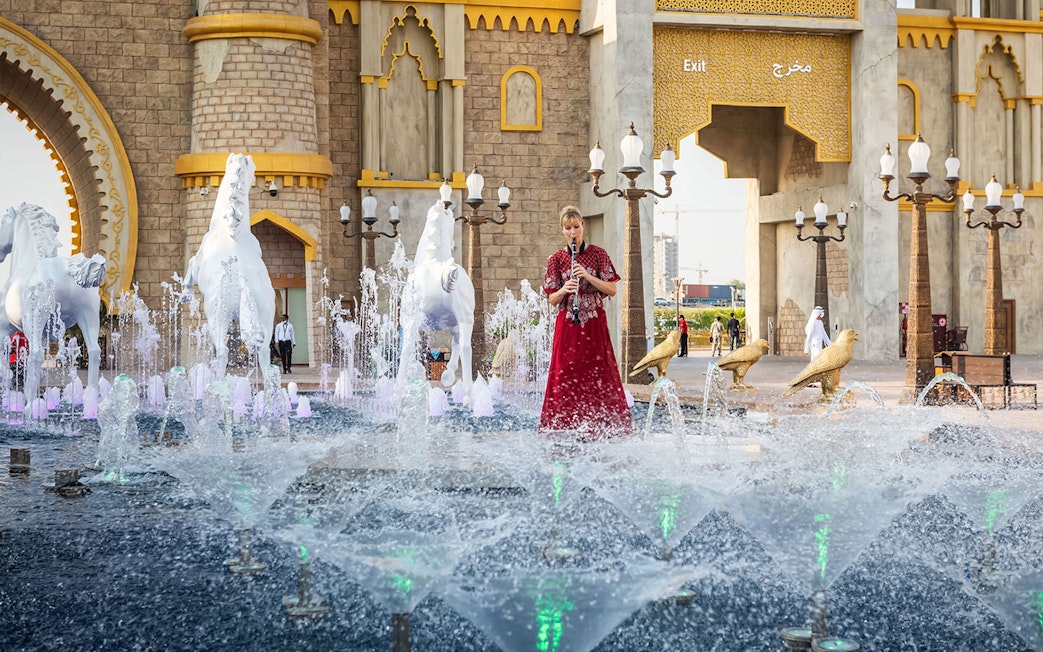 Fountain and performer at Global Village entrance, Dubai.