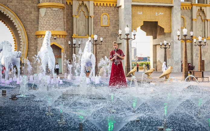 Fountain and performer at Global Village entrance, Dubai.
