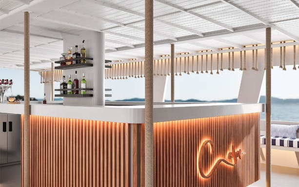 Bar area on a boat during a Palma Bay tour, featuring shelves with bottles and a view of the sea.