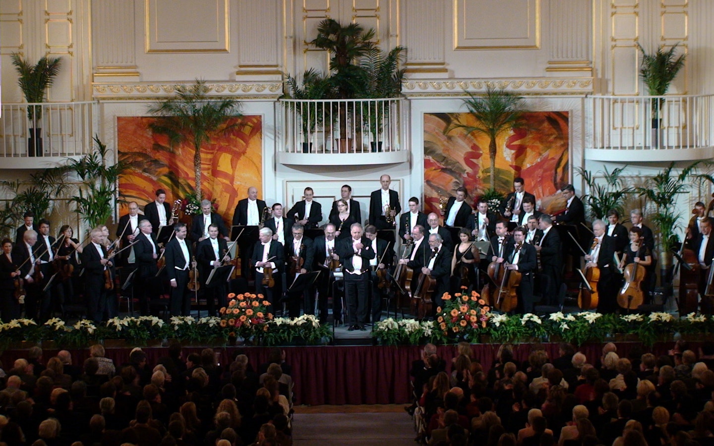 Vienna Hofburg Orchestra performing in a grand concert hall.