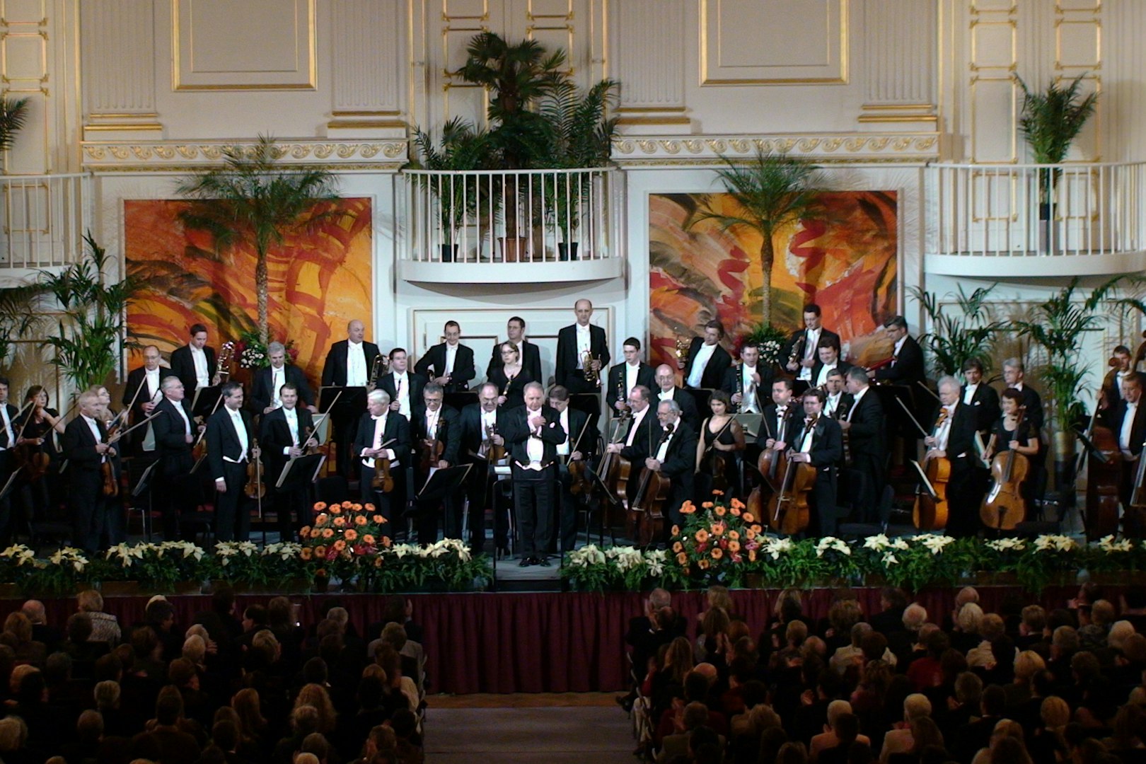 Vienna Hofburg Orchestra performing in a grand concert hall.