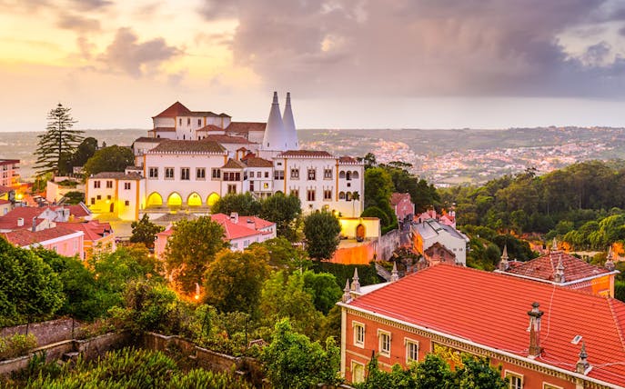 Sintra National Palace at sunset with surrounding landscape, Portugal.